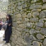 Feeling the vibrations against an ancient wall in Machu Picchu