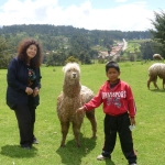 Karen with a Llama and his master in Cuzco, Peru